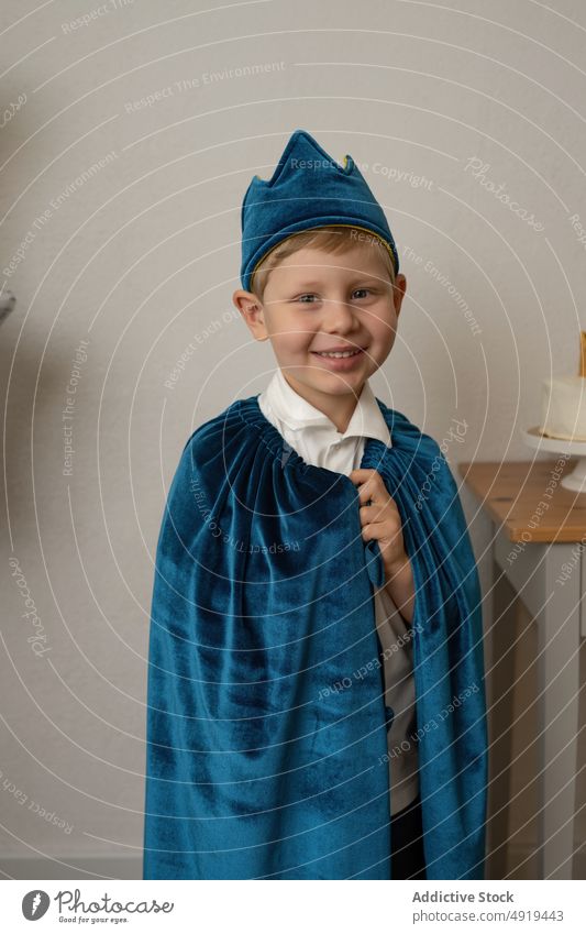 Boy dressed up with a blue cape having fun at a party child birthday crown happy holiday celebration cute boy childhood people background cheerful kid happiness