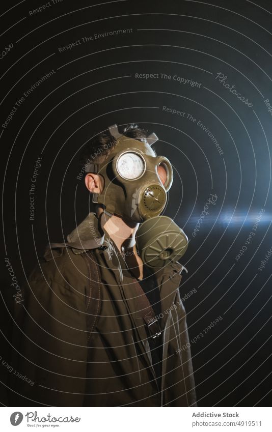 Anonymous man exploring underground tunnel explore gas mask apocalypse dark protect male explorer safety subway obscure discovery passage alone risk creepy