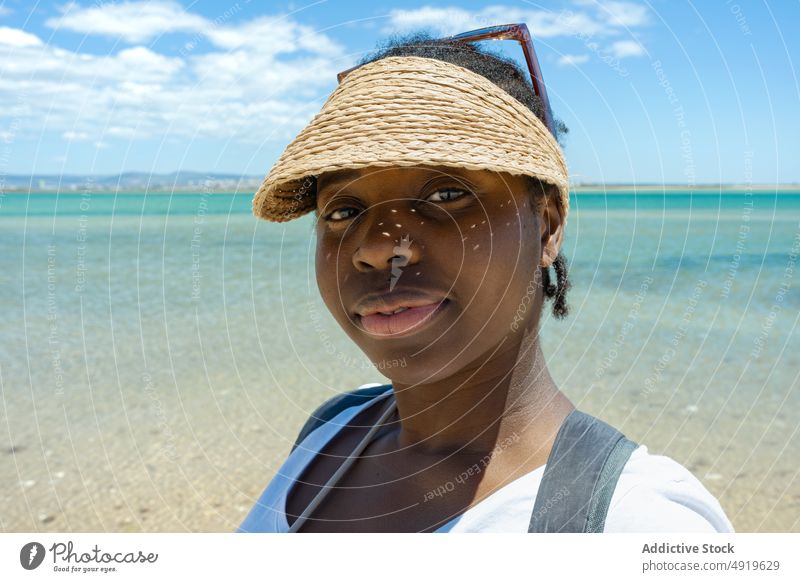 Portrait serious black woman on the beach and looking at camera sea seashore summer girl sand beautiful young portrait female lifestyle travel ocean vacation