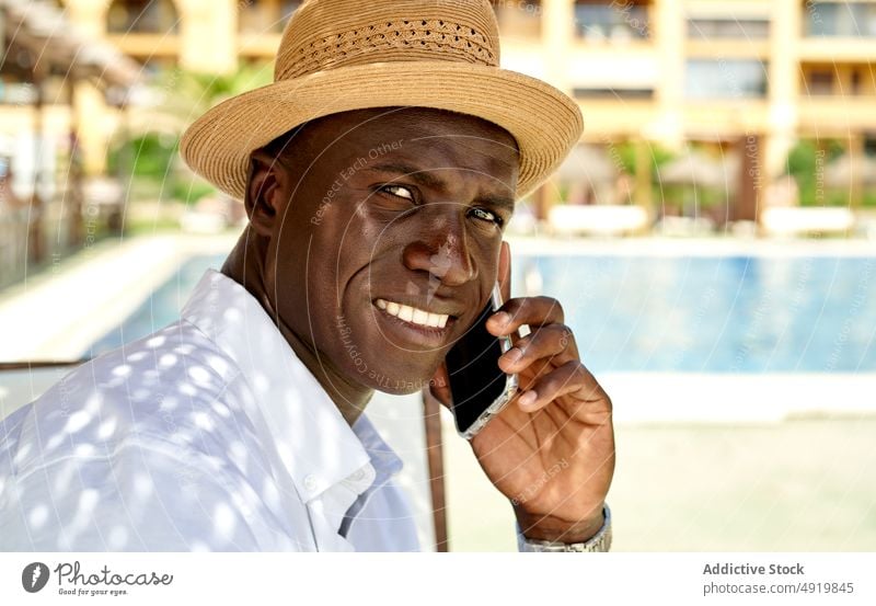 Black man having phone call on resort businessman smartphone conversation shore chat online sunbed coast surfing talk lounge seashore discuss speak communicate