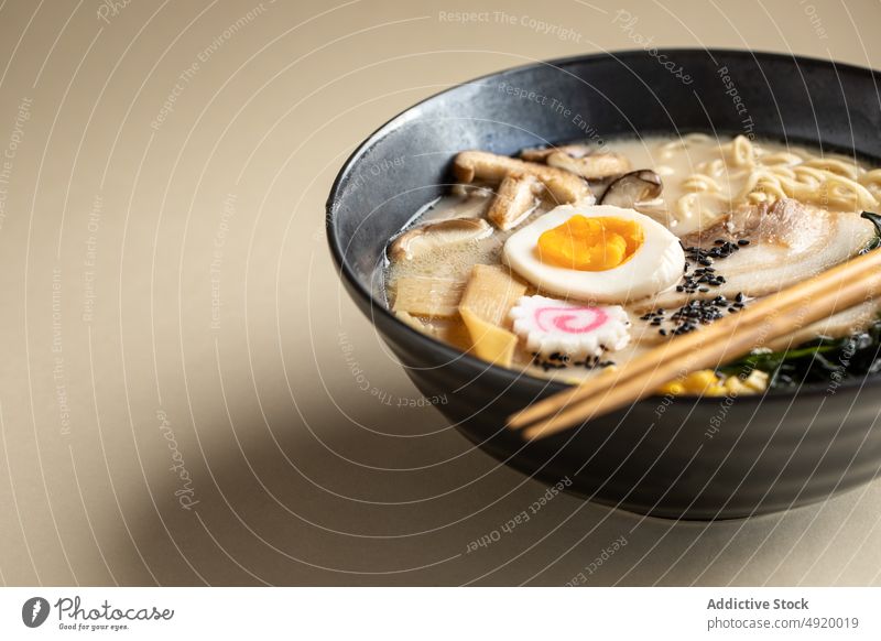 Tasty ramen with mushrooms and egg japanese noodle traditional culture dish ingredient flavor food meal bowl chopstick yummy appetizing delectable tasty serve