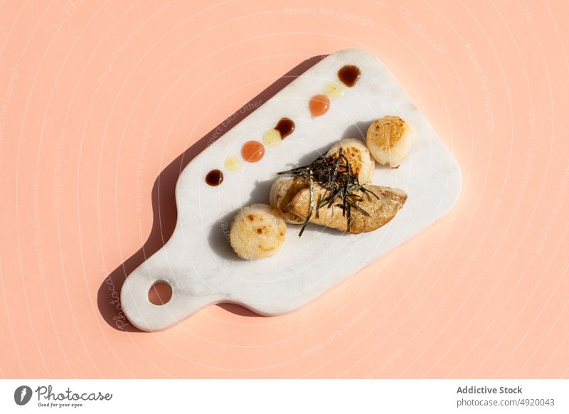 Scallops with foie gras on marble cutting board scallop seafood dish cuisine delicacy sophisticated haute cuisine exquisite ingredient serve fried delicious