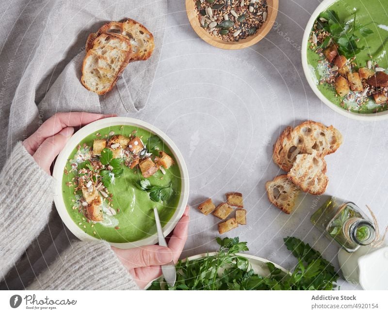Delicious vegetable cream with croutons woman hold soup parsley kitchen meal ingredient culinary homemade greens serve food vegan cuisine tasty nutrition bowl