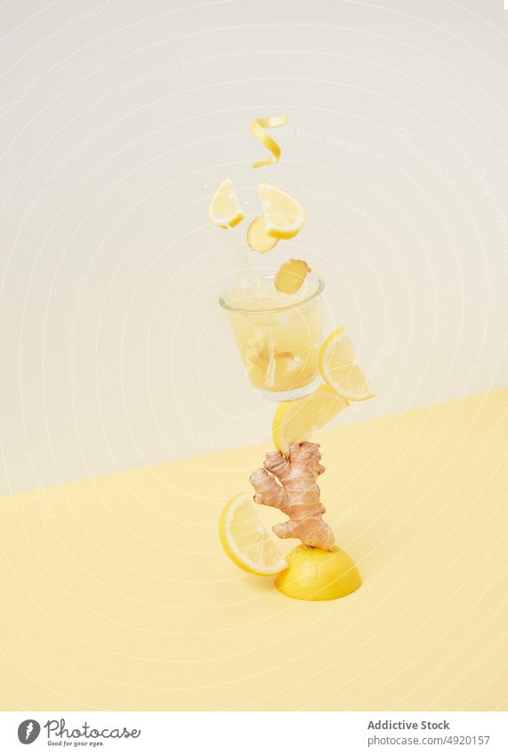 Lemons falling into glass with ginger lemon refreshment beverage drink citrus fruit vitamin healthy drink tasty cocktail ingredient slice organic delicious