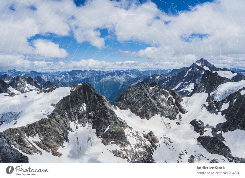 Scenic mountainous landscape with cloudy blue sky in sunlight range nature ridge picturesque scenery snow valley highland peak breathtaking switzerland alpine