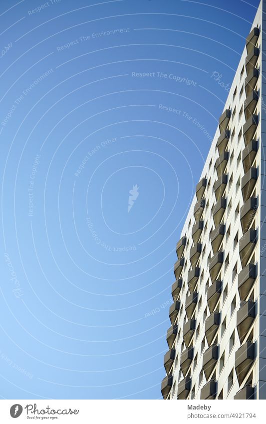 Refurbished high-rise building with balconies in front of blue sky in sunshine in Sachsenhauusen district at Hainer Weg in Frankfurt am Main in Hesse, Germany
