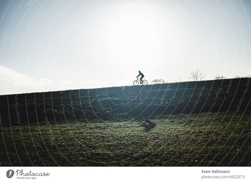 Cyclist on dike cycle Clouds Sky Outdoors Bicycle Cycling Shadow Silhouette Dike cyclists Lifestyle Movement Wheel Sports urban swift Speed Driving
