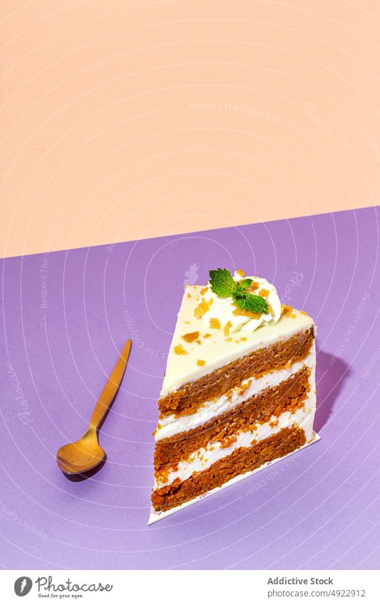 Slice of tasty carrot cake sweet dessert flavor confection treat slice pastry sponge indulge calorie yummy baked mint serve plate table spoon delicious food
