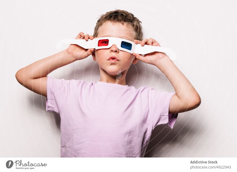 Boy with colorful 3D glasses boy 3d kid entertain vision amusement childhood hobby cardboard casual studio optical adorable style appearance sweet