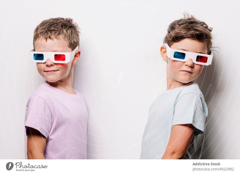 Happy children in 3D glasses 3d sibling vision cinema movie together calm hobby kid childhood paper boy girl casual studio optical adorable amusement style