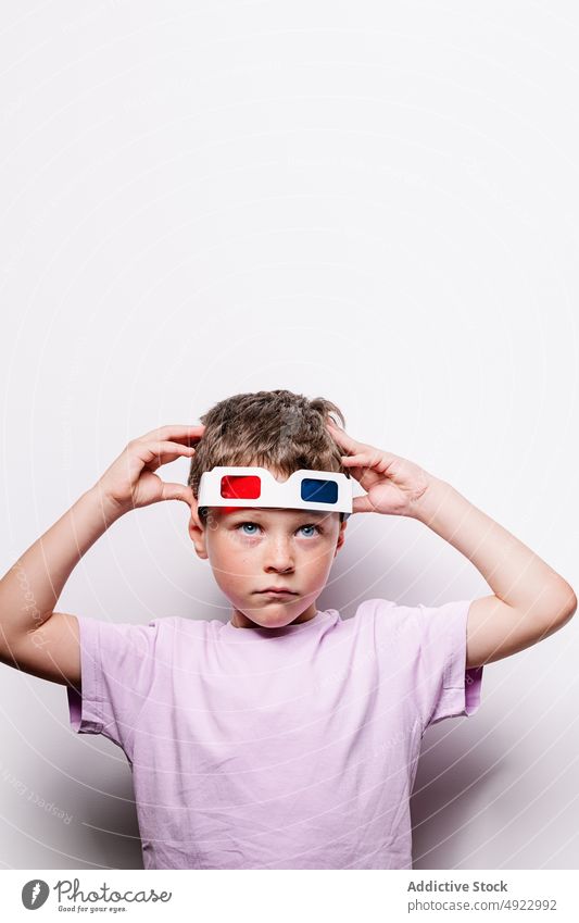 Boy with colorful 3D glasses boy 3d kid entertain vision amusement childhood hobby cardboard casual studio optical adorable style appearance sweet