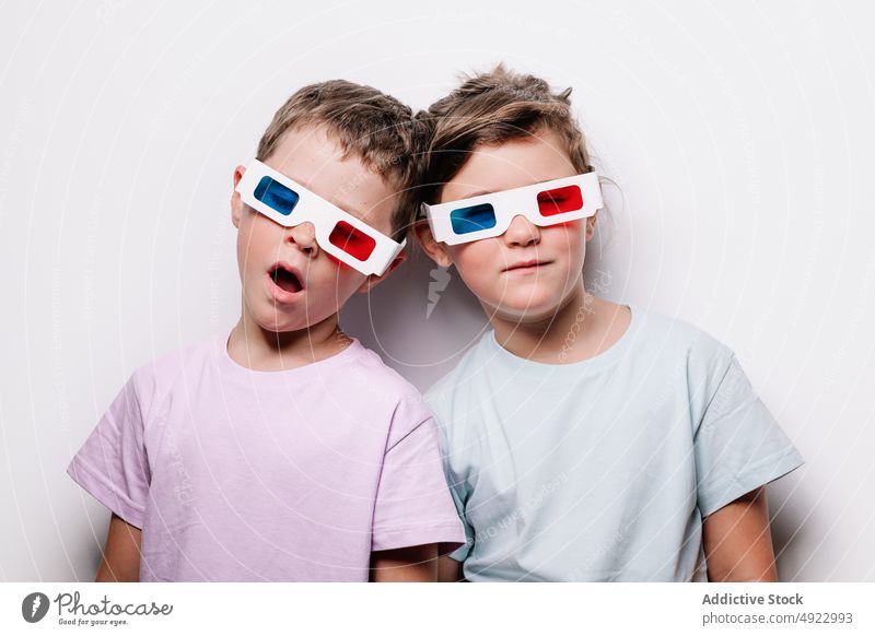 Serious children in 3D glasses 3d sleep tired sibling vision pretend cinema movie together calm eyes closed hobby kid childhood paper boy girl casual studio