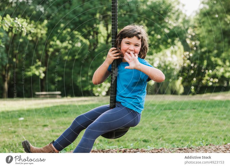 Little girl having fun on swing rope park play weekend summer rest smile hang child cheerful casual kid season relax glad little activity dry leaf daytime