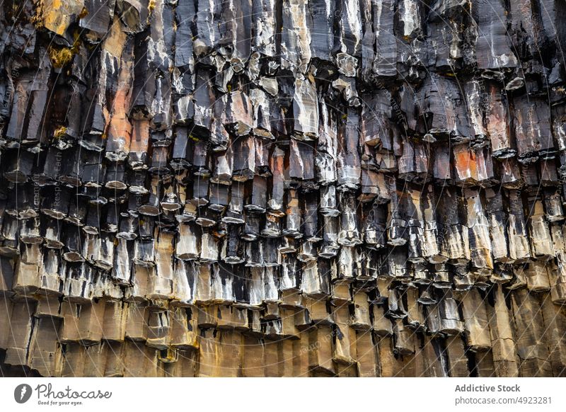 Basalt formation with natural columns in Iceland cliff basalt nature geology texture rocky abstract background surface rough massive mineral solid stone iceland