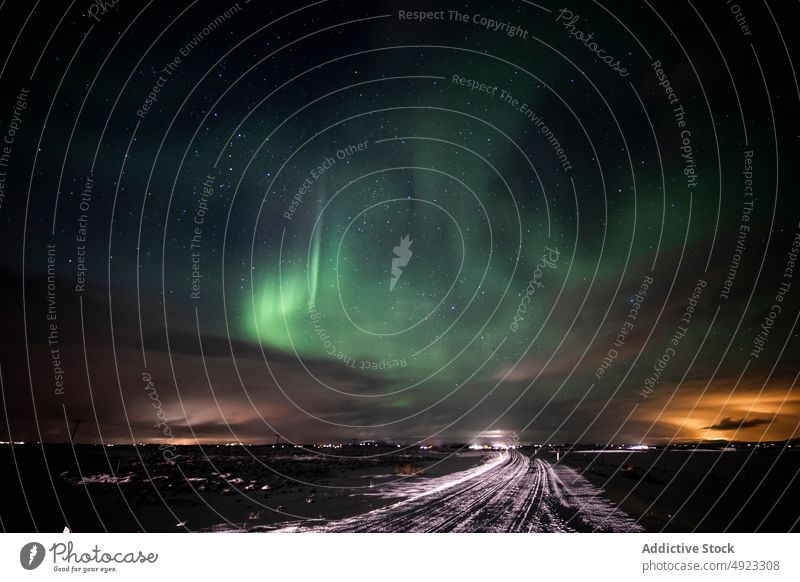 Road and mountains against northern lights road winter night snow countryside travel iceland polar evening nature landscape dark scenic way route frozen highway