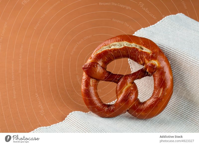 Fresh pretzel served on cloth bun composition pastry baked delicious fresh natural crust yummy bakery ribbed fabric appetizing gastronomy product organic