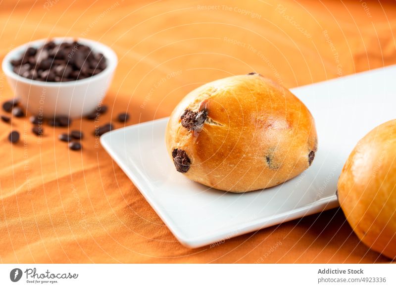 Chocolate chips buns on table chocolate morning breakfast plate sweet food serve fresh pastry dessert palatable gourmet portion baked treat delectable calorie