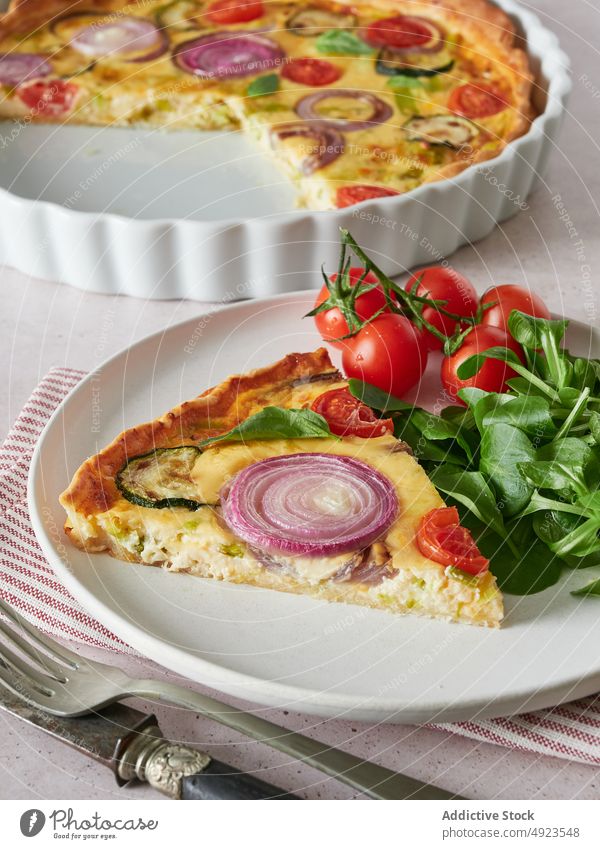 Quiche on plate with tomatoes and spinach quiche cherry tomato lunch serve vegetable dish piece fresh food cuisine gourmet delicious vegetarian gastronomy