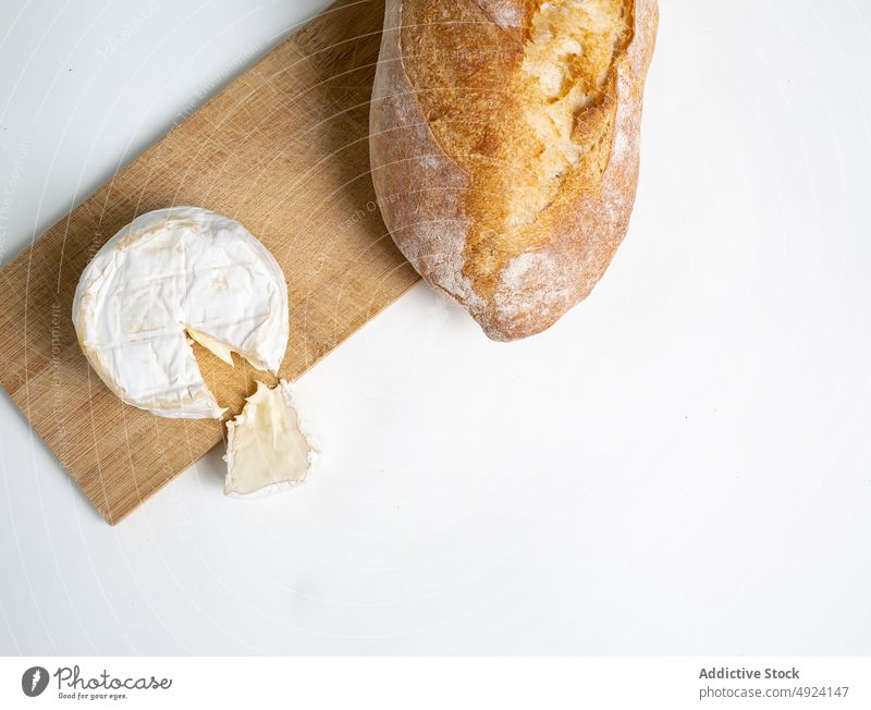 Camembert cheese and bread on cutting board camembert delicious wooden fresh yummy gourmet piece organic appetizing chopping board cuisine palatable natural