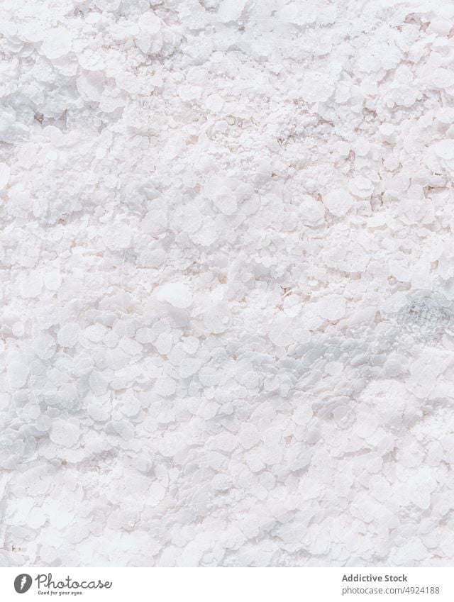 Salt flakes on white surface mineral salt rough natural crystal texture background geology abstract material uneven fragment dry detail formation rock clean