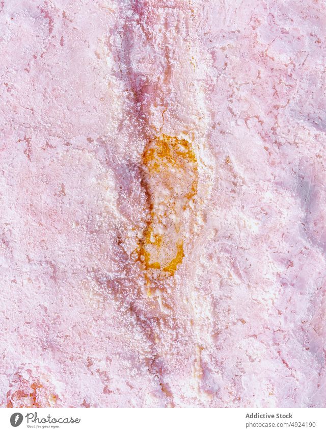 Pink marble with golden inclusion surface rough natural mineral pink texture background wall material detail rock abstract stone solid color uneven fragment