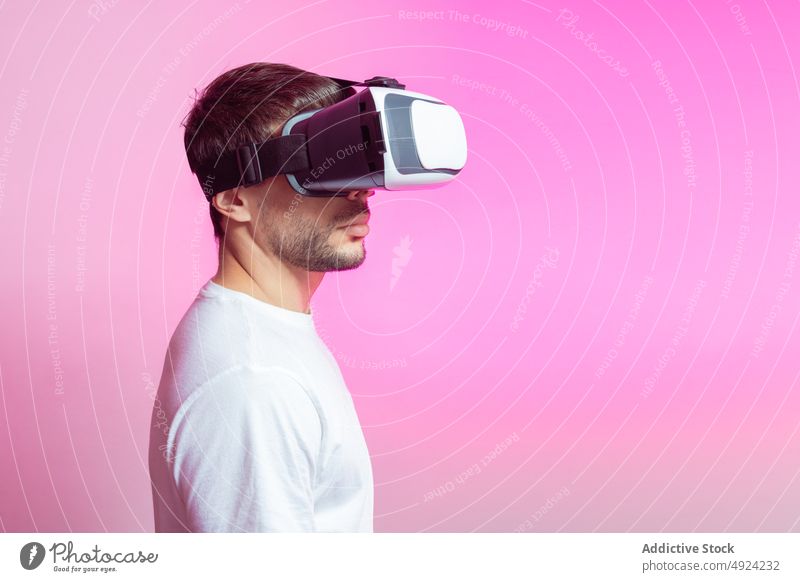 Man in VR glasses man vr virtual reality cyberspace futuristic high tech celebrate gamer modern immerse experience entertain simulate goggles headset male