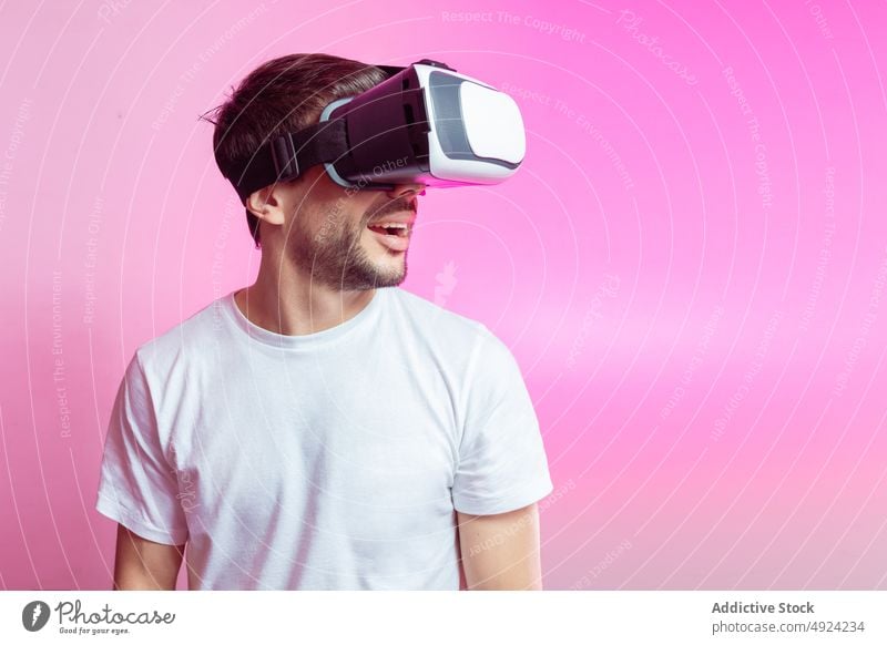 Cheerful man in VR glasses celebrating success vr virtual reality cyberspace futuristic high tech victory win celebrate gamer modern achieve triumph positive