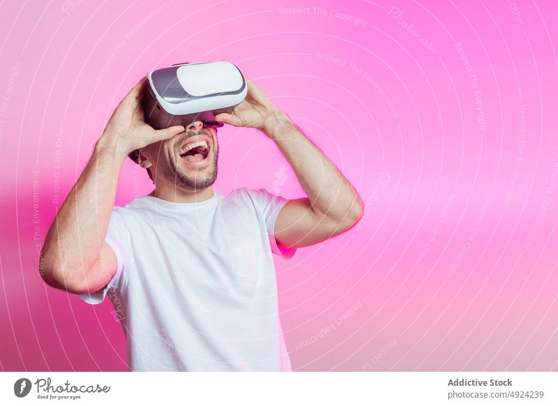 Cheerful man in VR glasses celebrating success vr virtual reality cyberspace futuristic high tech victory win celebrate gamer modern achieve triumph positive
