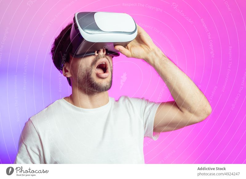 Amazed man in VR glasses vr virtual reality cyberspace futuristic modern immerse experience amazed simulate goggles astonish mouth opened shock headset male