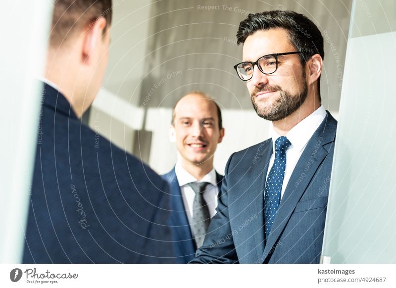 Group of confident business people greeting with a handshake at business meeting in modern office or closing the deal agreement by shaking hands. client success