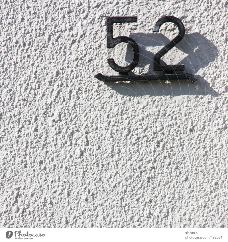 house number House (Residential Structure) Wall (barrier) Wall (building) Facade House number Digits and numbers Black White Living or residing Colour photo