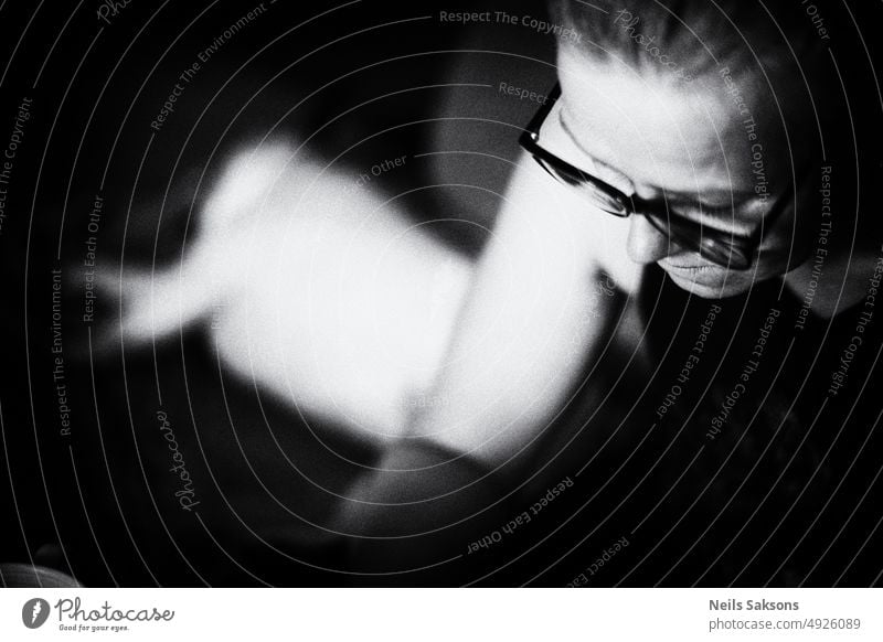 woman with glasses black and white lady portrait reading mono monochrome from above face hand spot vision book smartphone guess think pretty beautiful lovely