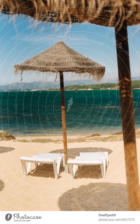 Deck chairs with straw parasols near the sea beach copy space spain paradisiac loungers deck chair caribbean atlantic coast waterside enjoy sky ocean travel sun