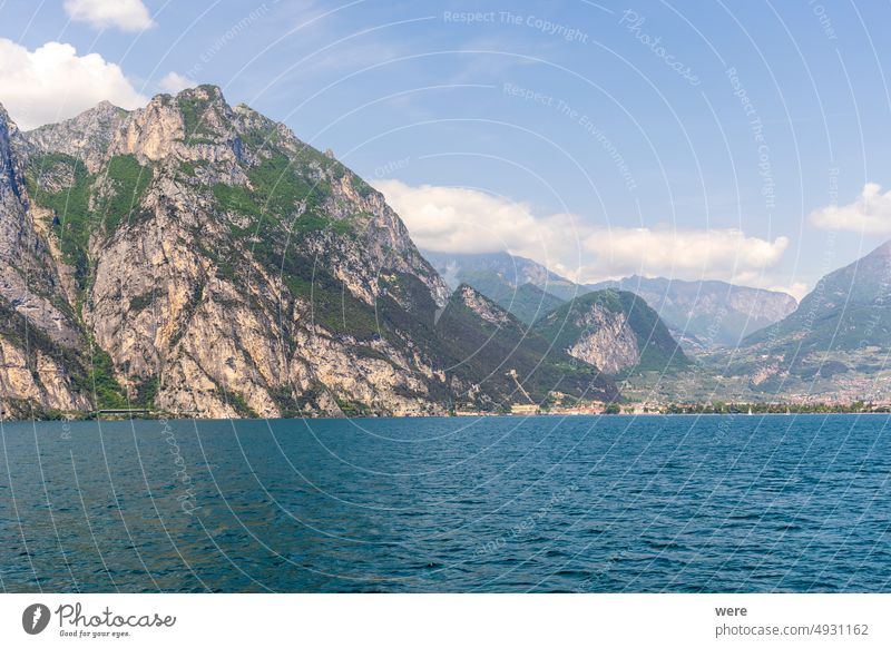 Wooded mountain top and rock wall on the northern shore of Lake Garda in Italy Mediterranean Rock wall alps climbing copy space italian italy lake landscape