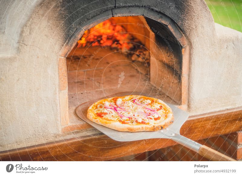 Delicious pizza from a hot outdoor stone oven stove outdoors italian food wood fire pastries neapolitan pizza calorie margherita hungry rotary shovel original