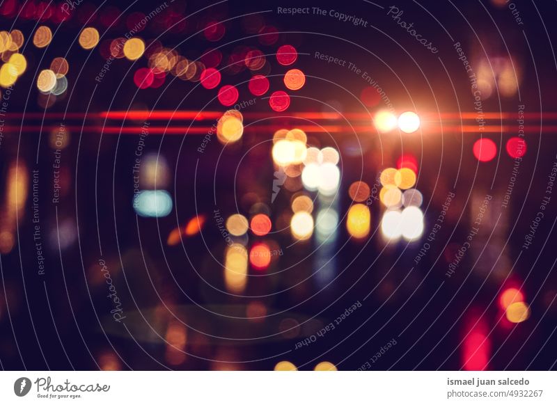 defocused street lights at night in the city colors colorful multicolored bokeh circles bright shiny blur blurred outdoors abstract pattern background textured