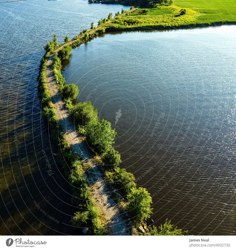 View of a breakwall on Lake Butte des Morts in Oshkosh Wisconsin shoreline sunny fox river jagged nature water day lake background summer drone midwest usa