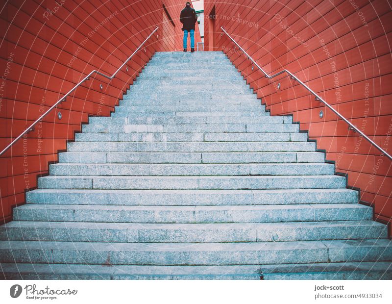 Man on stairs between two walls Stairs Wall (building) Architecture Banister Lanes & trails Pedestrian Structures and shapes Wide angle Symmetry Authentic