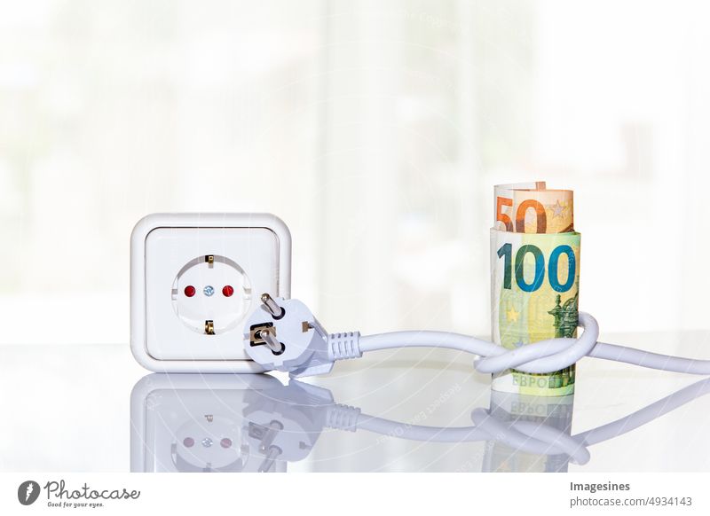 Socket and roll of euro banknotes, knotted with a power plug, extension cord. Concept of saving electricity at home on light background. Electricity costs and expensive energy concept. Power consumption