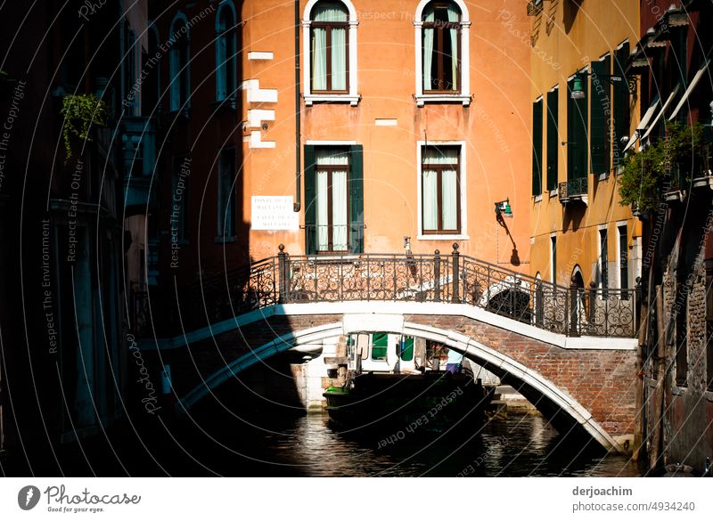Small bridge in the canals of Venice, half in the sunshine. In the background a house front. Bridge over water Day Water Architecture Manmade structures