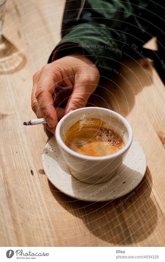 One hand holding an espresso and a cigarette Espresso Cigarette Hand Coffee Cup espresso cup Smoking To have a coffee Coffee cup Nicotine kofein Addiction drugs