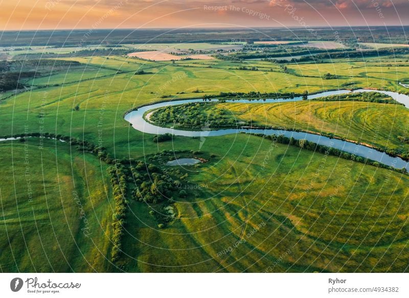 Belarus. Aerial View Of Green Forest, Meadow And River Landscape In Sunny Evening. Top View Of European Nature From High Attitude In Summer Sunrise. Bird's Eye View