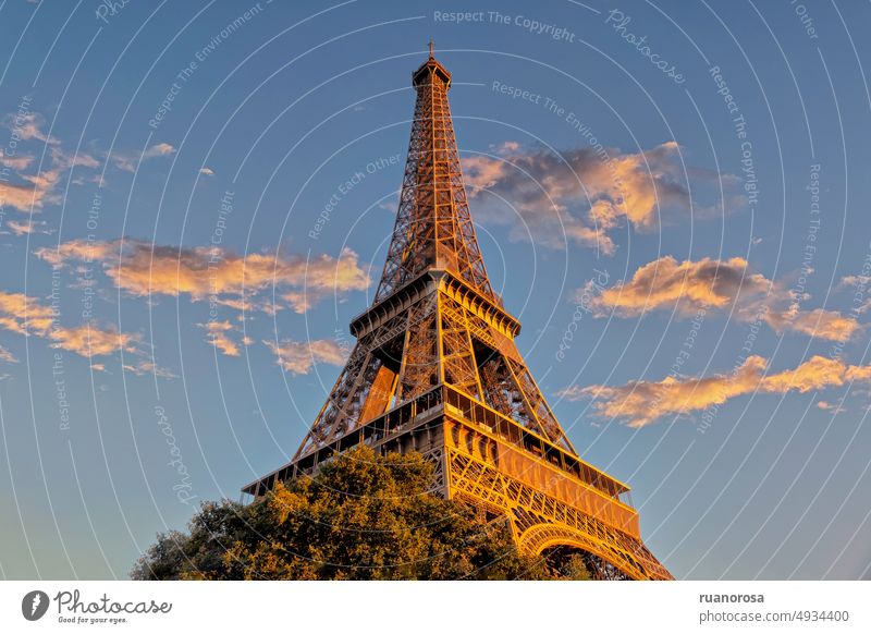 Image of the Eiffel Tower from the base, worm's eye view, against the blue sky and evening light above it Paris France cityscape famous symbol france romantic
