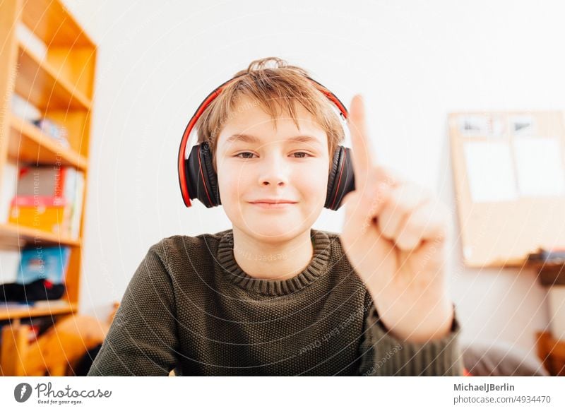 Home schooling boy in video chat camera 10 years Ten age alert attention caucasian child closeup conference distant european face finger home learning looking