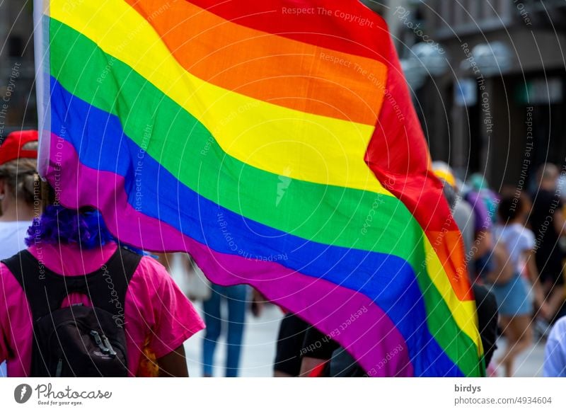 Demonstrator with rainbow flag at CSD for gender justice, gender recognition, respect and tolerance. LGBTQI Prismatic colors lgbtqi Homosexual equality queer