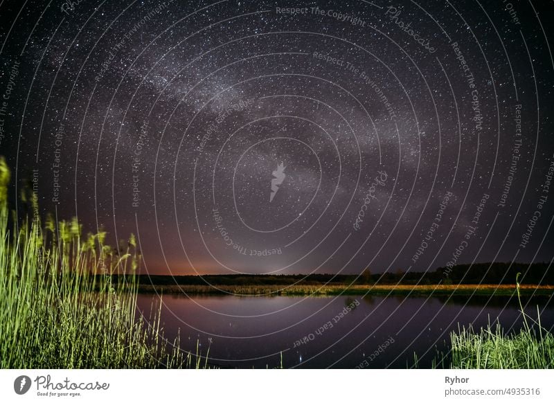 Milky Way Galaxy In Night Starry Sky Above River Lake Pond In Spring Night. Glowing Stars Above Landscape. View From Belarus, Europe astronomy beautiful belarus