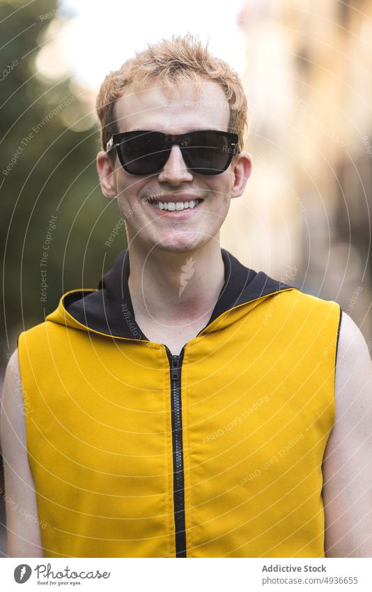 Smiling stylish non binary male on street man style urban cheerful delight transgender confident modern lgbt glad young happy smile lgbtq sunglasses daytime