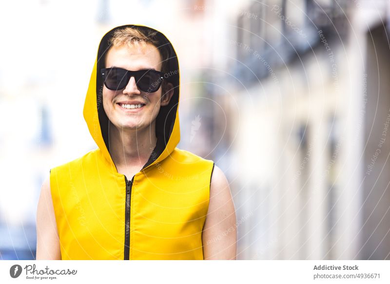 Smiling stylish non binary male on street man style urban pavement cheerful delight transgender confident modern lgbt glad young happy smile lgbtq sunglasses