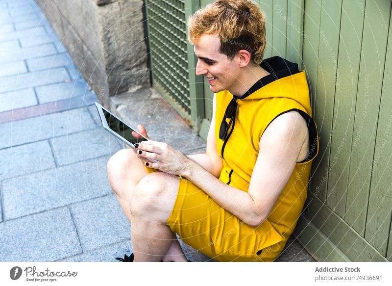 Non binary male using tablet man street non binary transgender lgbt evening online house young transsexual gadget device internet browsing urban connection