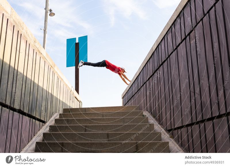Man jumping over stairs during parkour in city man trick stunt hipster street moment male urban stairway leap freedom energy activity extreme guy step perform